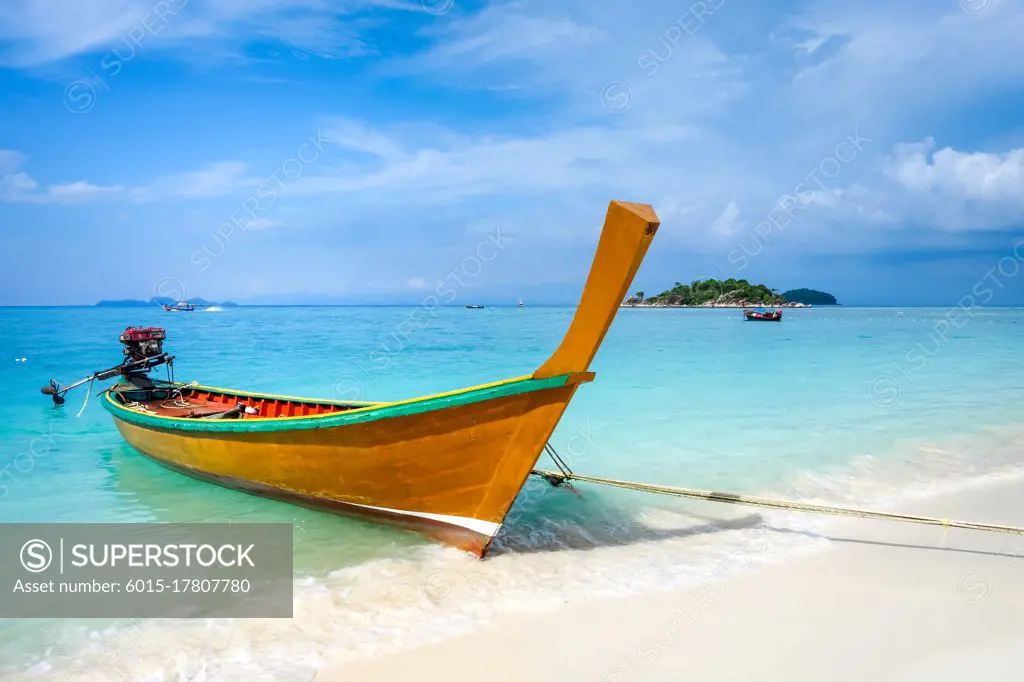 Traditional long tail boat on sunrise beach, Koh Lipe, Thailand