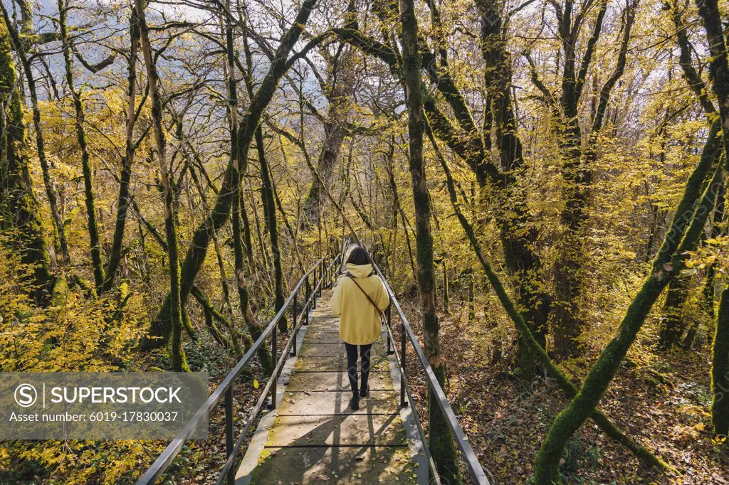 Woman walking in autumn park