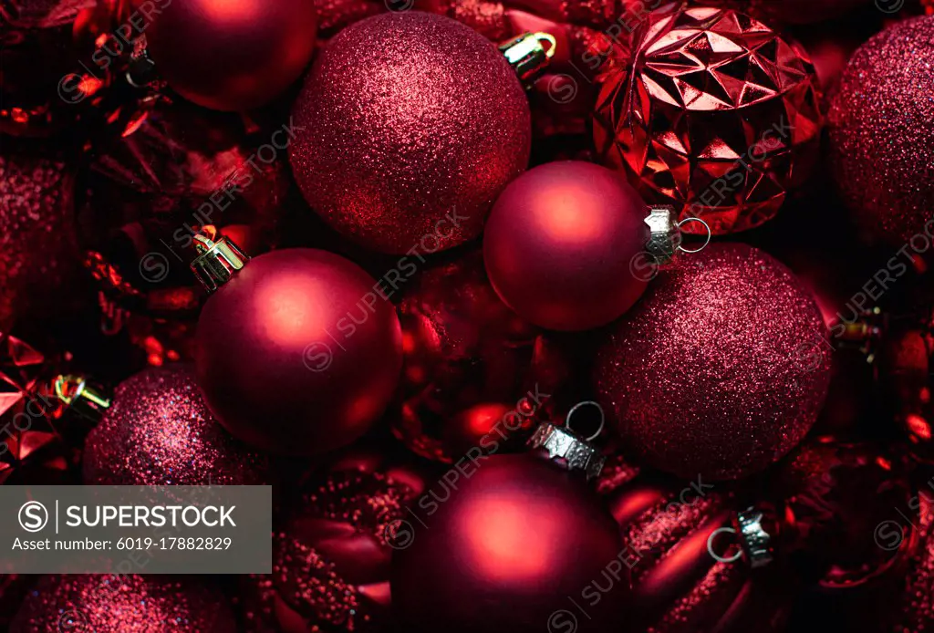 Close up red Christmas ball decorations with various textures.