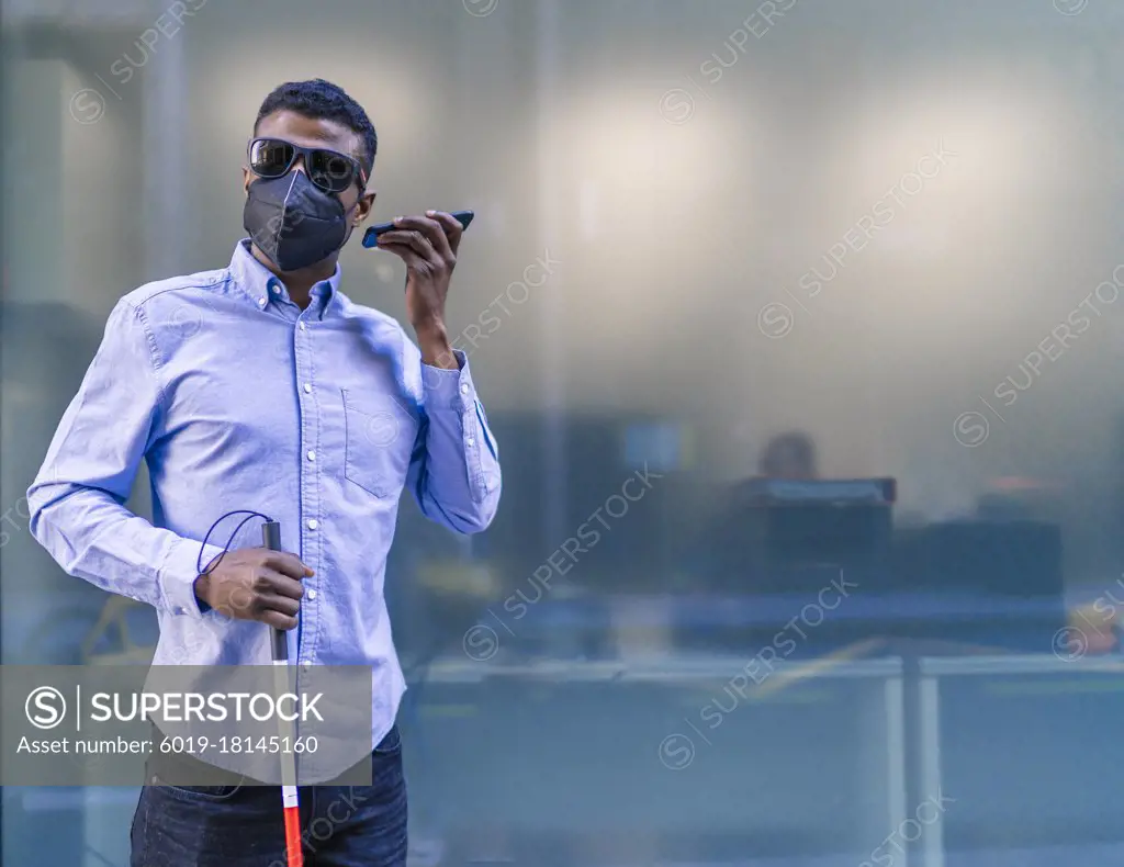 young blind african man talking on his smartphone