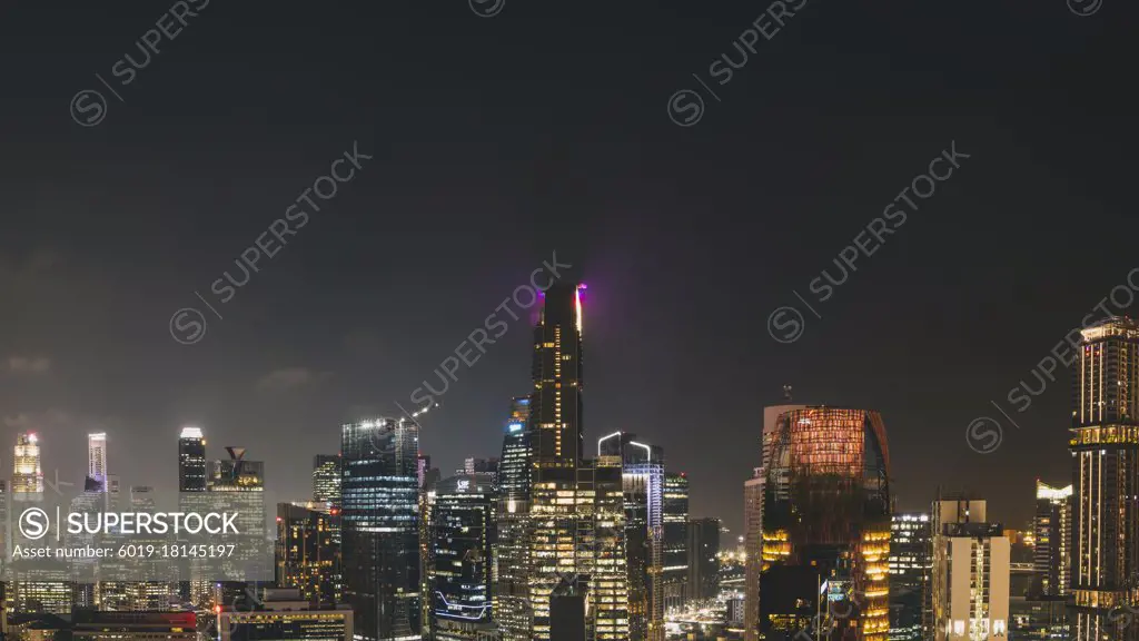 Panorama cityscape of Singapore city skyline at night from a rooftop viewpoint.