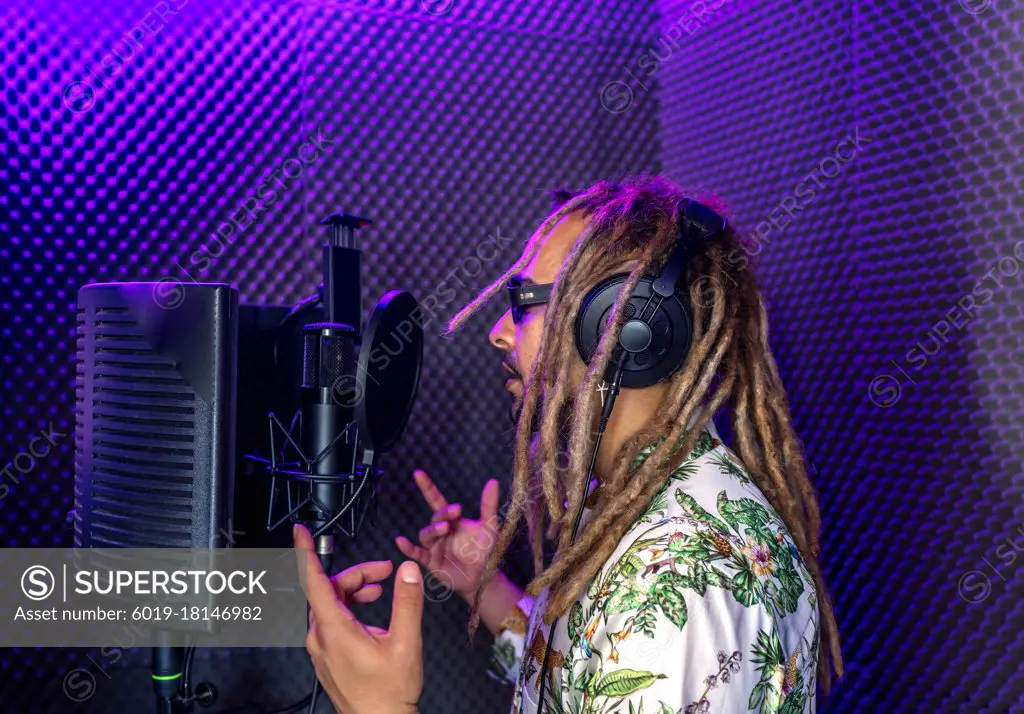 Rasta recording his song in a recording studio