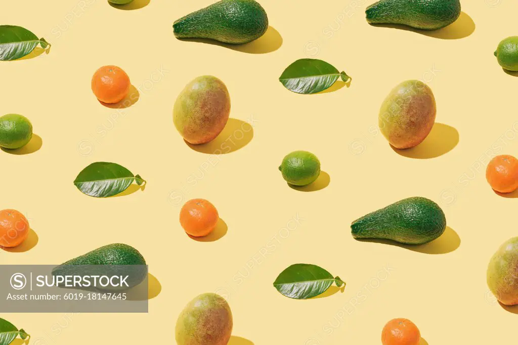 Background pattern with fresh fruit and green leaf layout on pas