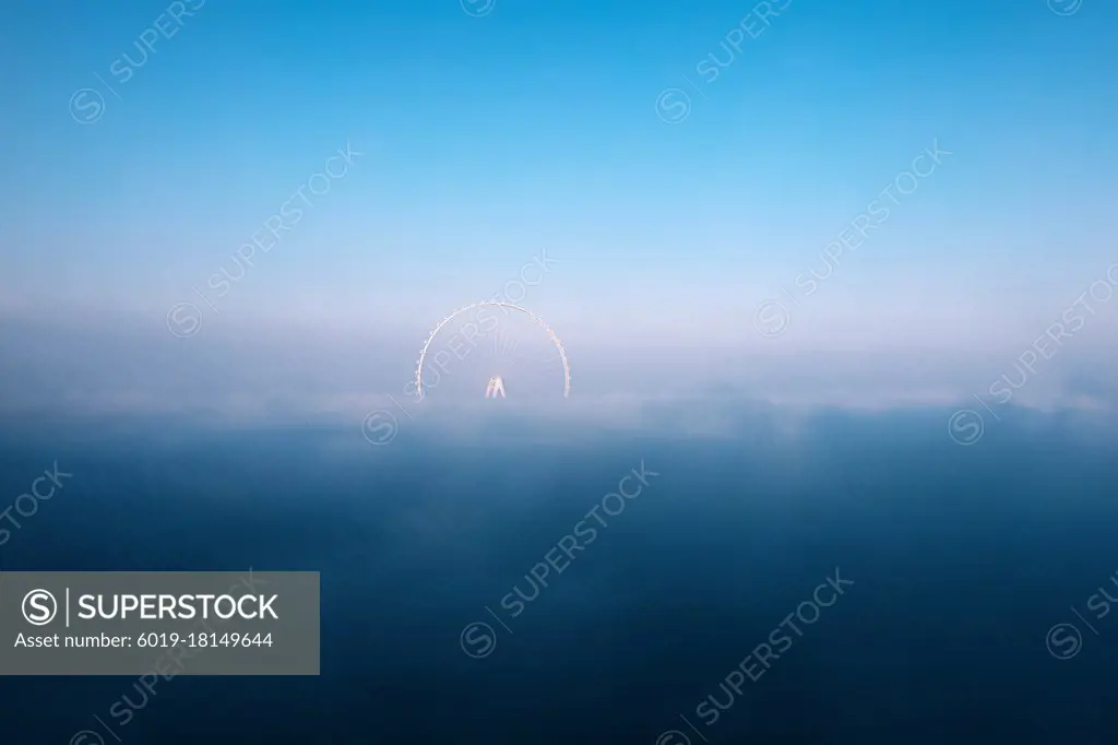 Scenic background with fog on Dubai eye ferris wheel