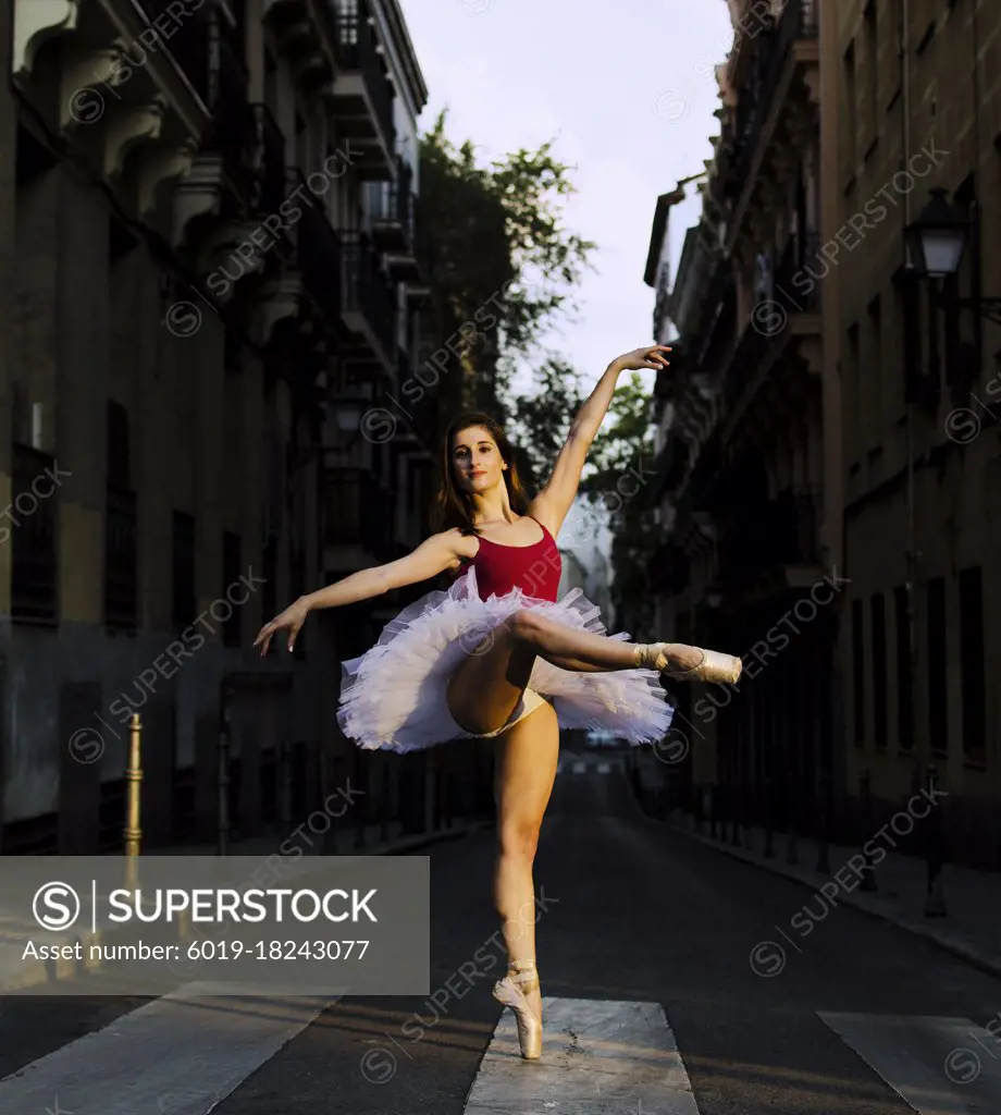 Portrait of a young ballerina on pointe shoes in the street