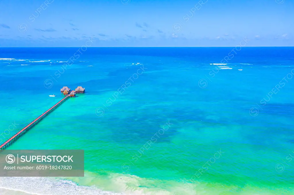 Aerial view of beautiful hotel in Indian ocean at sunset in summ