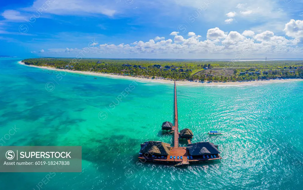 Aerial shot of the Stilt hut with palm thatch roof washed with t