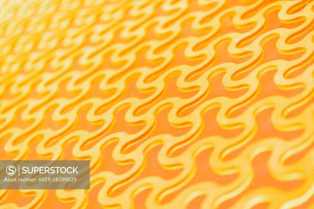 Abstract background, a repeating pattern of gold curved round cells in a gold lattice.