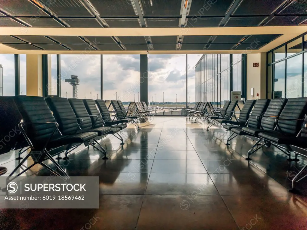 Empty airport departure area lounge on the background of the window