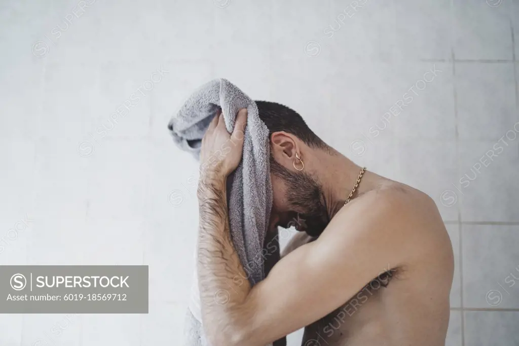 close up white man drying himself at home in his bathroom