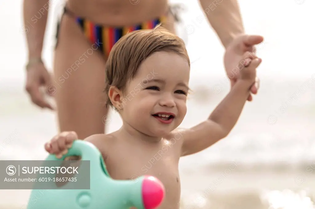 beautiful girl with her mother on the beach