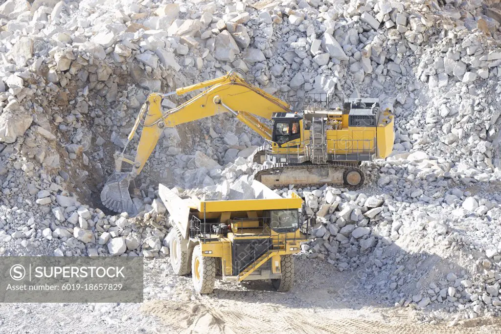 cradler working with big rocks from aerial view