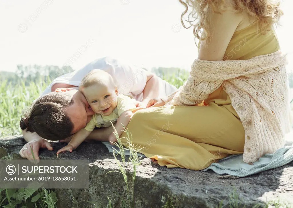 father kissing his son in the park