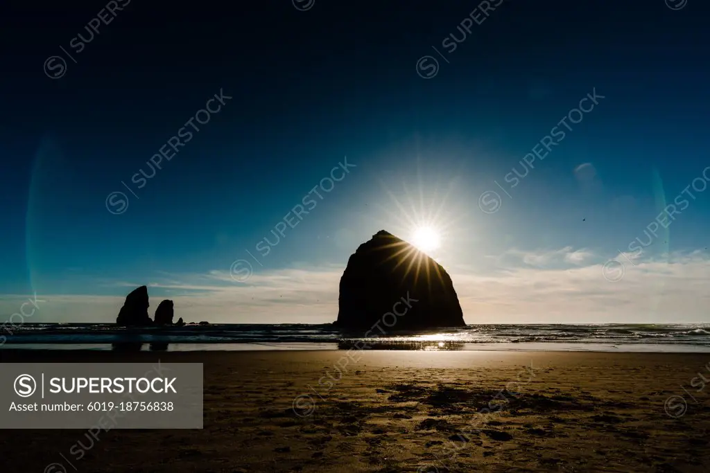 Moody image of haystack rock just before sunset