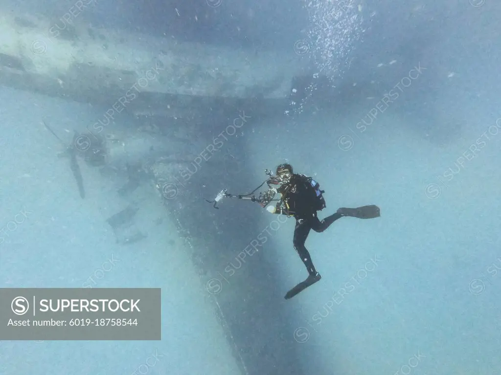 scuba diver photographing a shipwreck