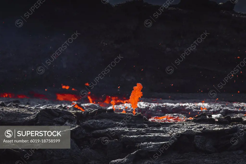 incandescent flowing volcanic lava in volcano