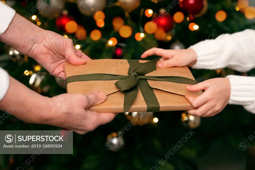 a girl receives a gift from an elderly woman