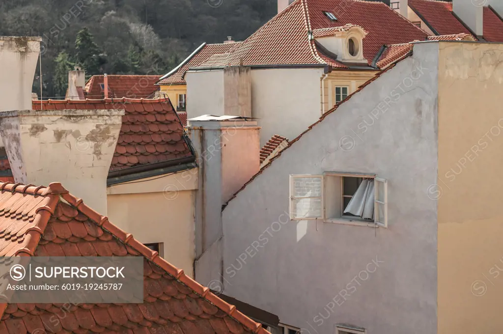 View of an open window with a curtain in the Old Town in Prague.