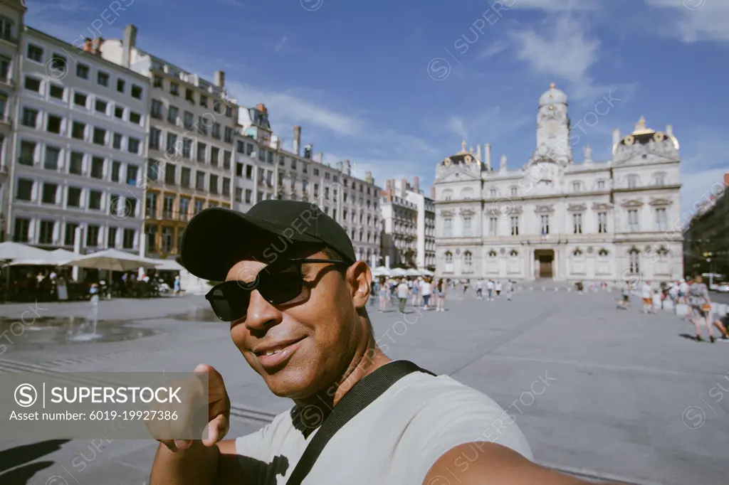 handsome young Latin taking selfie in city of lyon, france