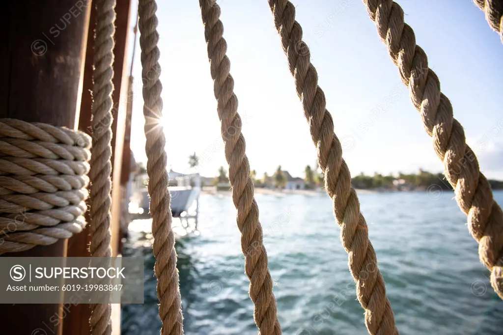 Sunlight coming through ropes on dock in Hopkins Belize