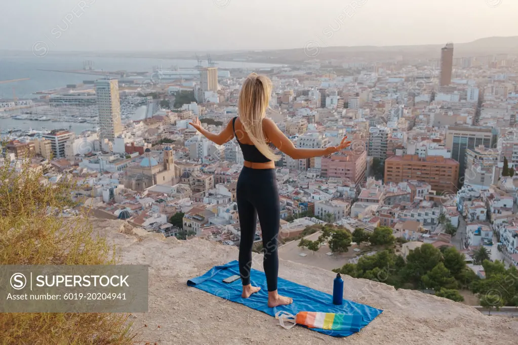 girl does sports and yoga outdoors on gay pride day