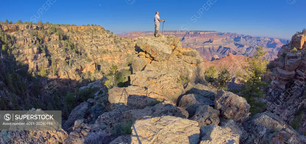 Hiker climbing boulders at Grand Canyon AZ