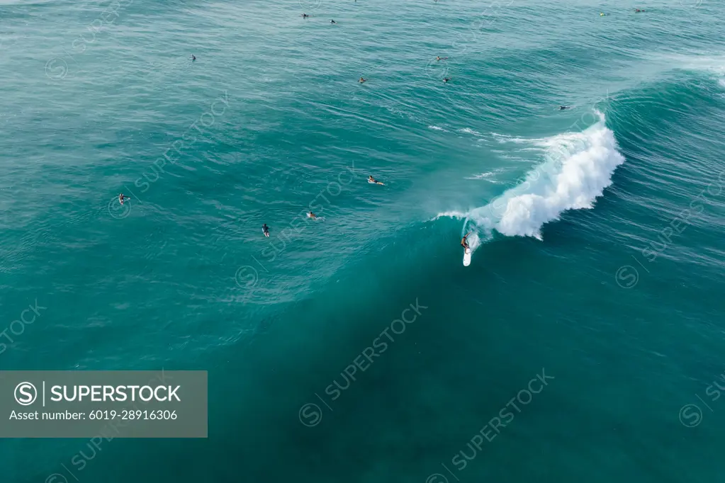 Surfer in hawaii gets barreled on a wave