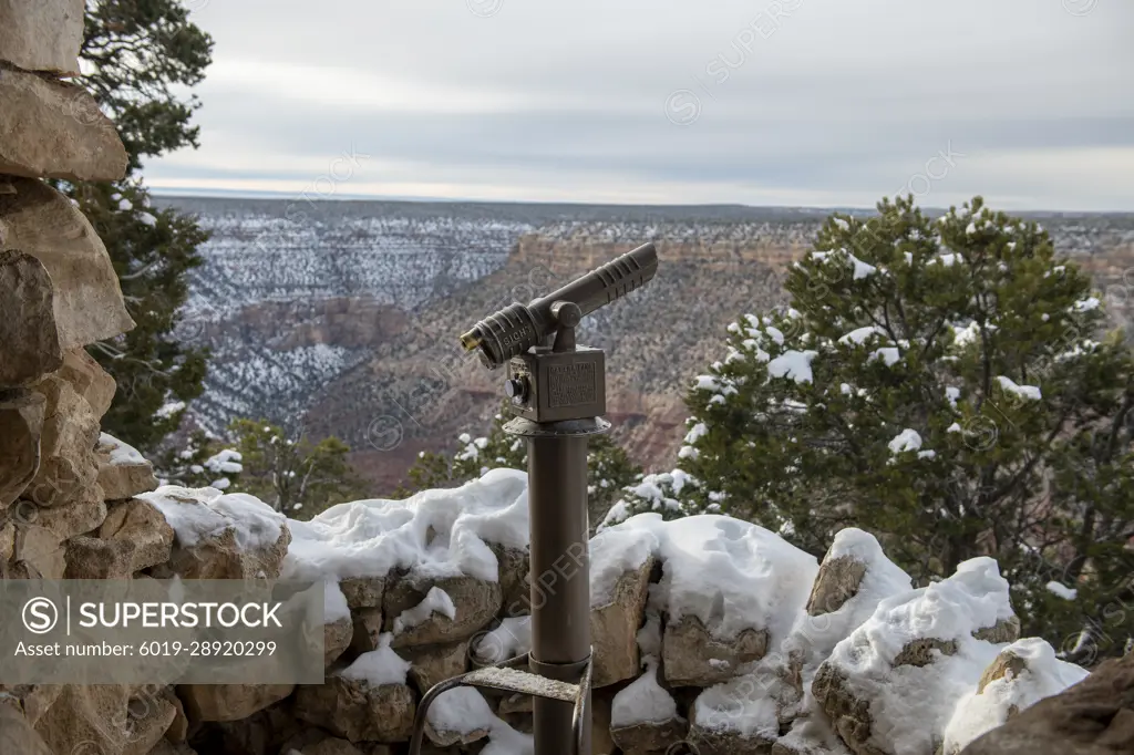 Snow covered coin-operated viewer at a South Rim Grand Canyon overlook