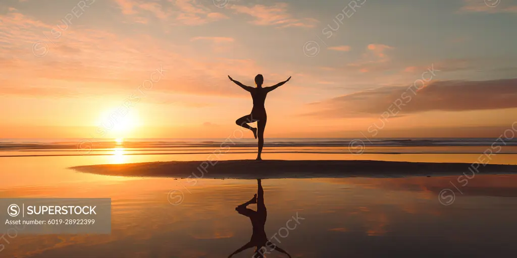 Doing yoga by the beach at sunrise. Soul and spirit. Generative AI