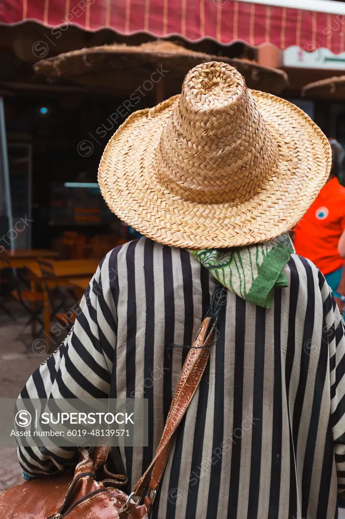 Berber person with a straw hat and traditional attire