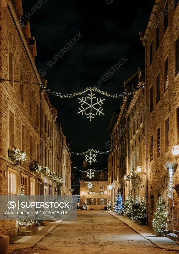 Old street Quebec City lit up at night decorated for Christmas holiday