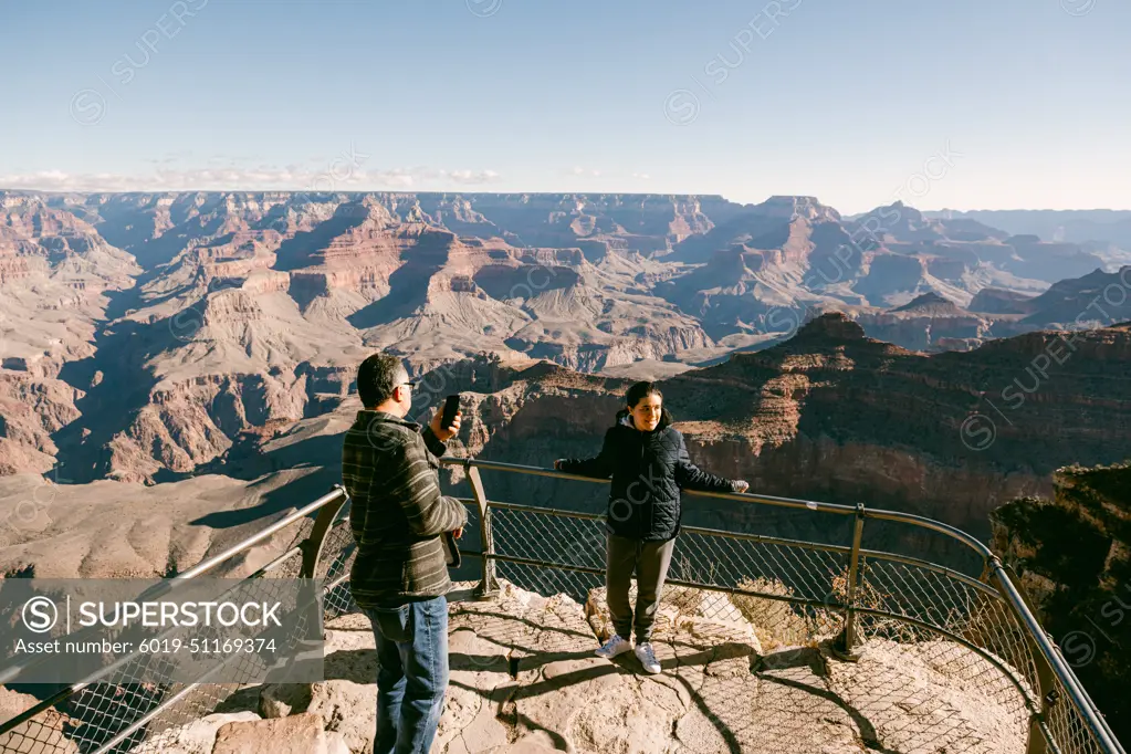 Dad taking photo of daughter at The Grand Canyon