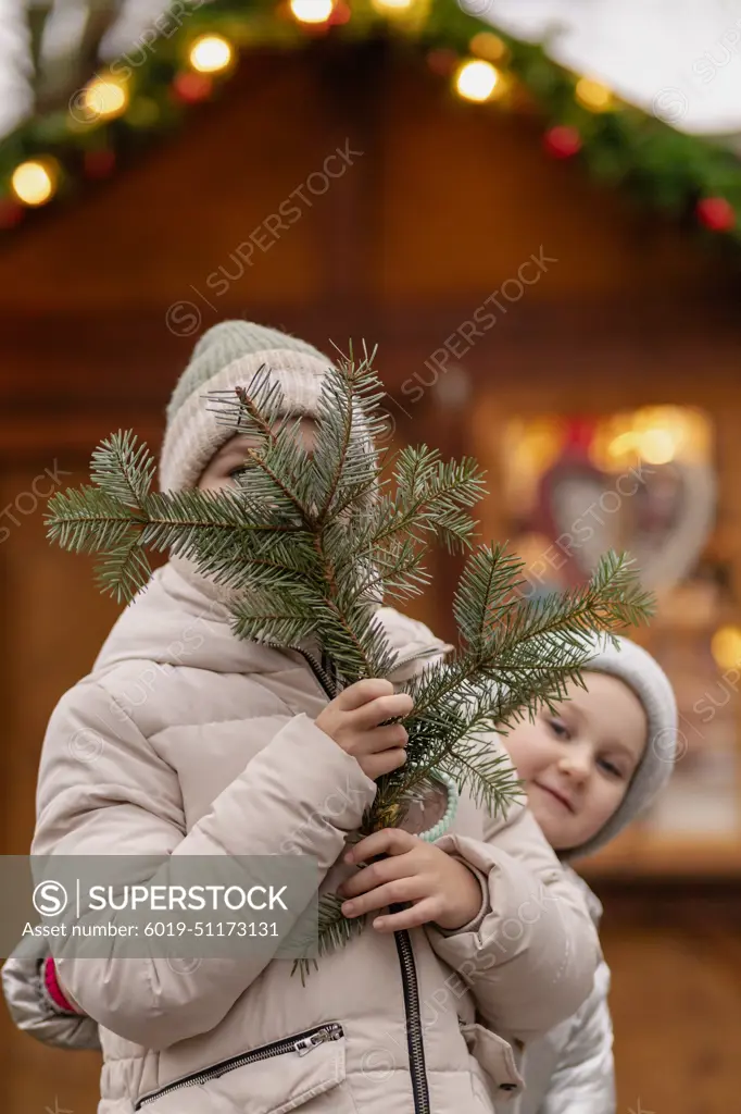 Two girls walk at the Christmas market in Germany, gingerbread