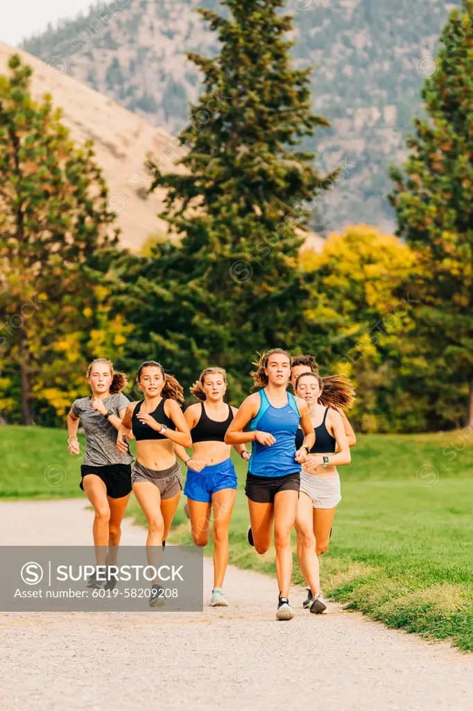 College female student athletes running during track practice