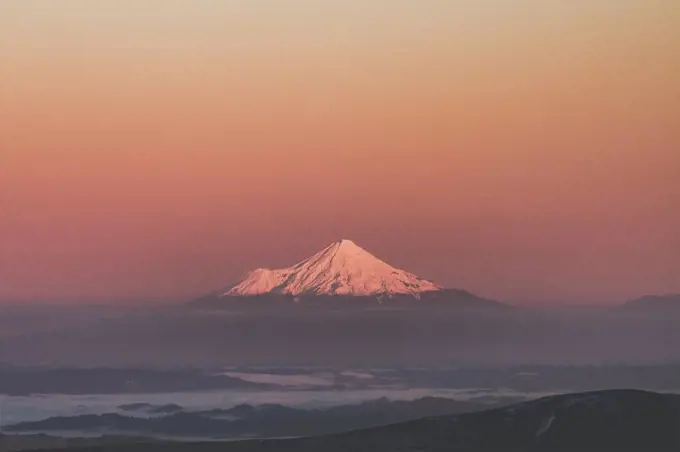 Mount Taranaki rising in the mist at sunrise, Tongariro National Park, New Zealand