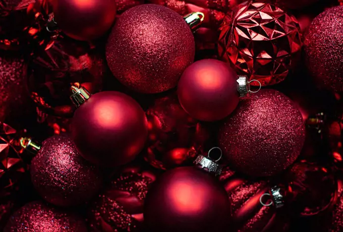 Close up red Christmas ball decorations with various textures.