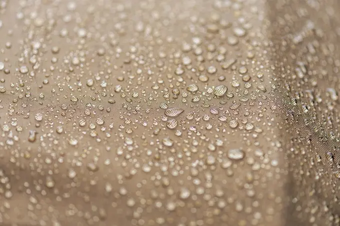 Drops of rain, water on a waterproof fabric close-up.