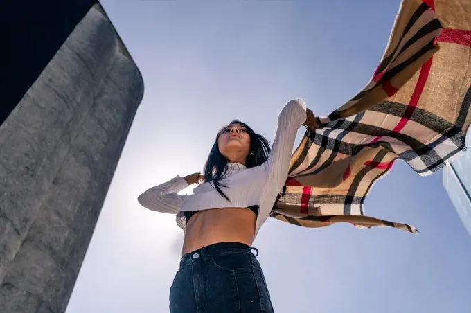 Young Latin woman moving and playing with a ruana.