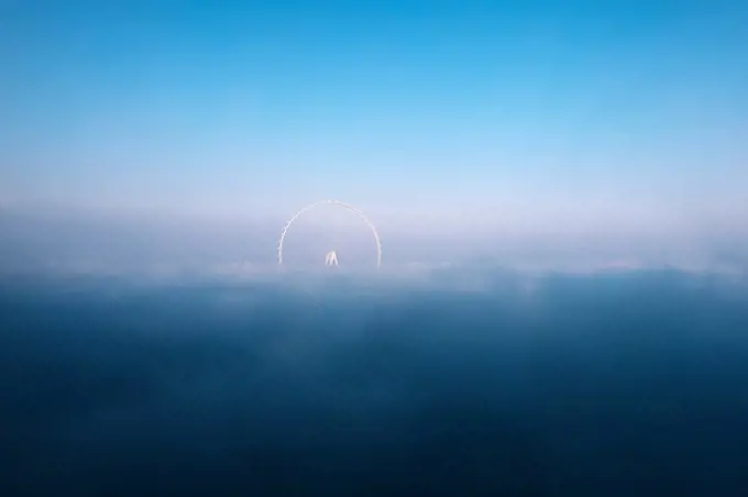 Scenic background with fog on Dubai eye ferris wheel