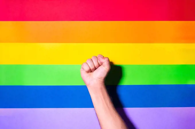 Hand fist with lgbt flag background. Lgbt pride concept.