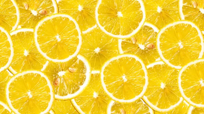 Organic lemon fruit slices natural juicy background.