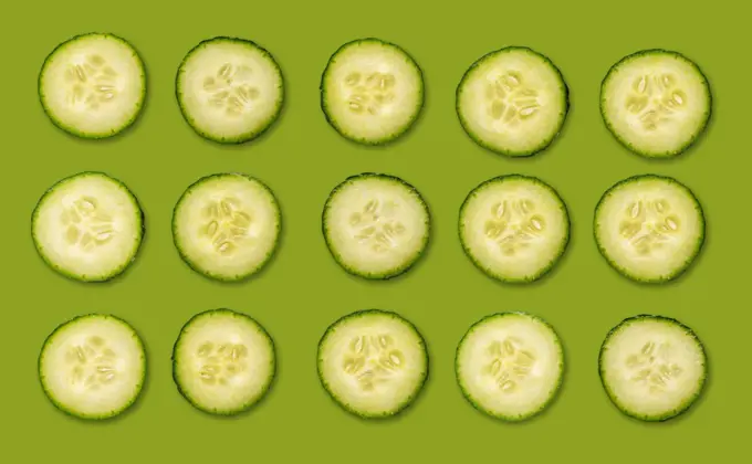 Fresh organic cucumber slices natural juicy pattern background.