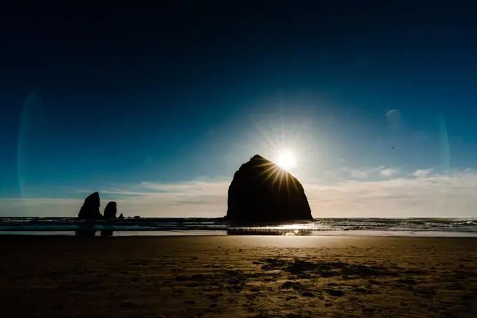 Moody image of haystack rock just before sunset