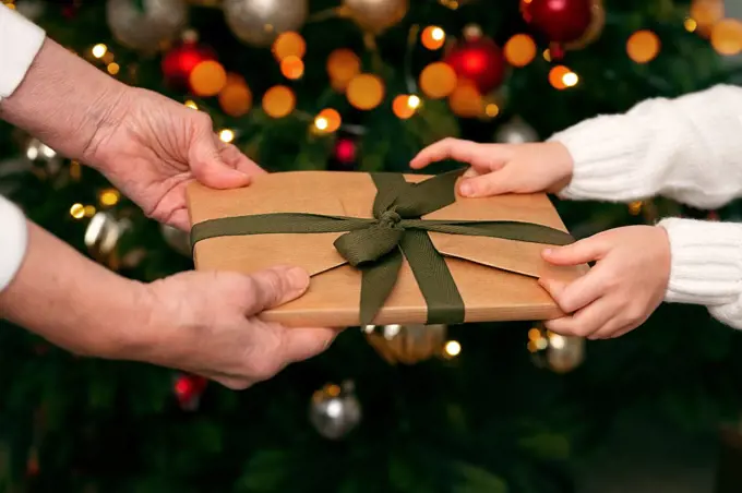 a girl receives a gift from an elderly woman