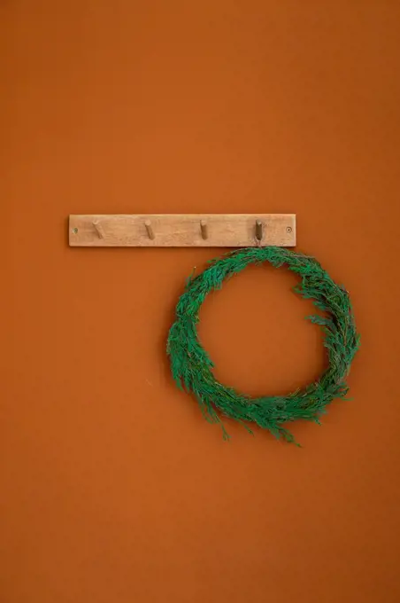 Christmas tree wreath on orange brown wall