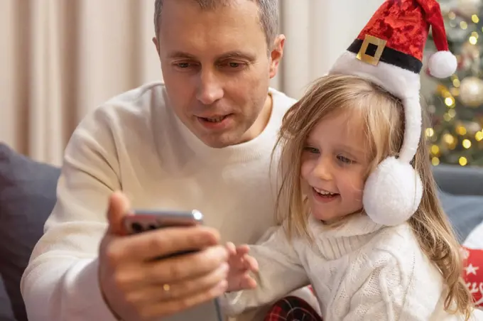 father and daughter talking on video call