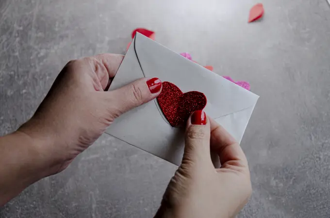 letter with heart in hand