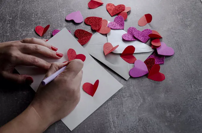 hands sign a love letter