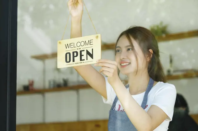 Young business owner open the coffee shop.