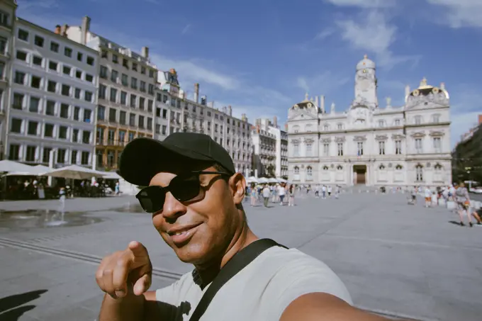 handsome young Latin taking selfie in city of lyon, france